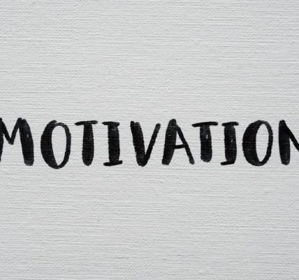 Inspirational word 'Motivation' in black on a white textured canvas background.